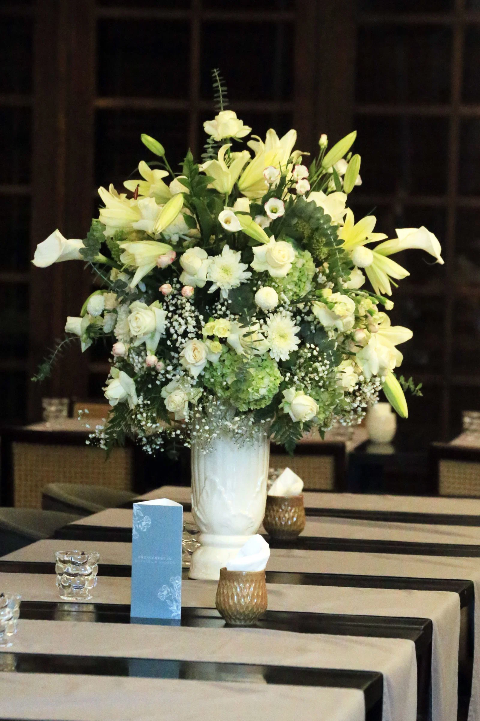 A white floral arrangement at a memorial service